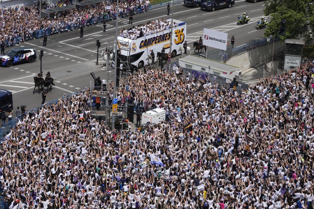 Real Madrid team players celebrate on an open-topped bus in Cibeles Square a week after clinching La Liga title in Madrid, Spain, Sunday, May 12, 2024. 